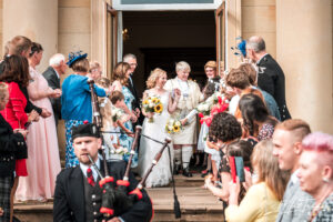 Scottish piper brides sunflowers just married LGBTQ same sex confetti family wortley 300x200