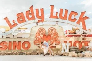 Couple kissing under Lady Luck Neon Sign 4 640 1 300x200