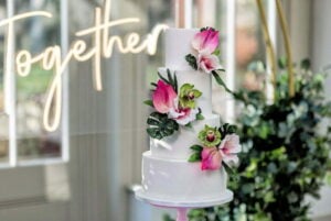 4 tier white wedding cake with tropical sugar flowers Plum Park Manor 1 300x201