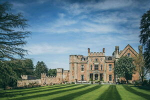 Rowton Castle. Front of the Castle with Striped Lawns and Blue Skies 300x200
